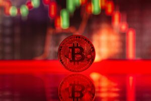 Close-up image of a Bitcoin coin with trading graph reflection, symbolizing cryptocurrency market dynamics.